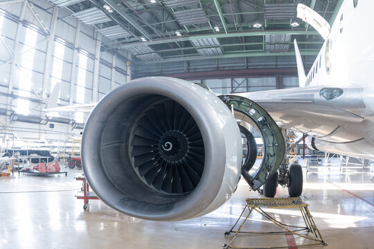 Close-up of an open high bypass turbofan aircraft engine of a passenger plane in airplane hangar