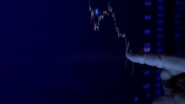 AI humanoid robot arm reading financial data on a monitor. Premium low-key close-up shot of artificial intelligence in business.