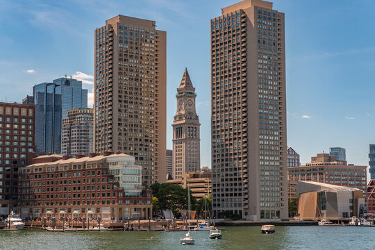 Boston, MA, US-June 8, 2026: Boston Skyline viewed from Boston Harbor with skyscrapers, Rowe's Wharf and boats.