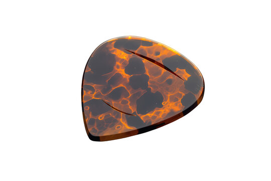 Tortoiseshell guitar pick with amber and brown pattern, essential plectrum for playing music, isolated on transparent background