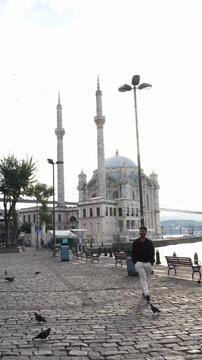 Male Traveler Exploring Ortakoy Mosque by the Bosphorus