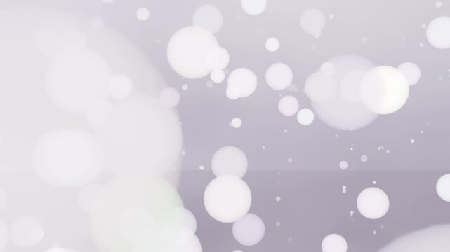 Flashing white burst starting bokeh orbs and sparks drifting in gray backdrop, creating faint bands
