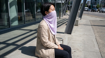 Fototapeta premium Pale Lavender UV Scarf on Urban Transit Bench in Midday Sun