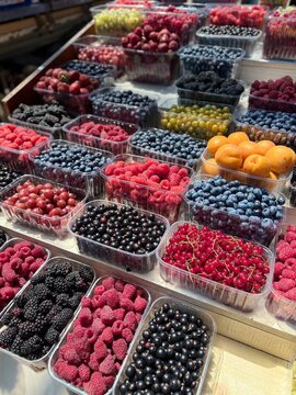 Fresh mixed berries and apricots at local farmers market healthy summer produce
