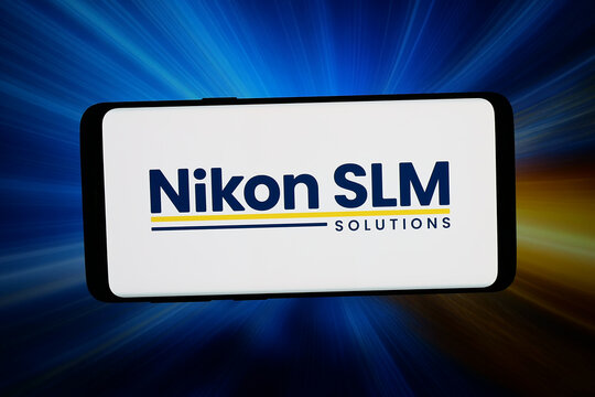 Stuttgart, Germany - 06-22-2026: In this photo illustration, the logo of machinery company Nikon SLM Solutions AG is displayed on a smartphone in front of abstract background on computer screen.