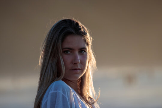 Woman enjoying golden hour sunlight outdoors