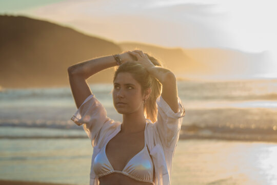 Woman enjoying golden hour sunset on beach