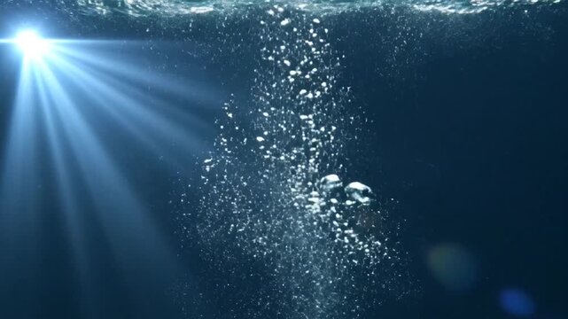 Underwater scene with bright light rays illuminating rising bubbles in dark blue water Keywords: underwater, water, bubbles, light rays, sunbeams, deep sea, ocean, aquatic, dark blue, light