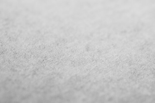 Monochrome macro shot of a white piece of printer paper, shallow focus
