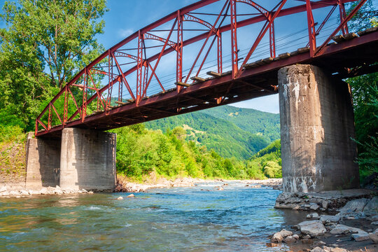 rail bridge in mountain landscape in summertime. outdoor adventures in highland of ukraine, rakhiv district on a sunny day