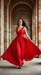 Fototapeta premium Elegant Woman in Flowing Red Dress Walking Through Stone Arches