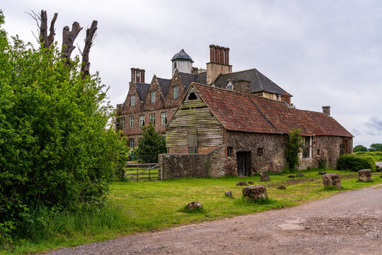 Naas House, a historic landmark in Gloucestershire, England, showcasing traditional architecture amidst a natural landscape.