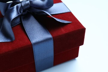 Fototapeta premium Beautiful velvet gift box on light blue background, closeup