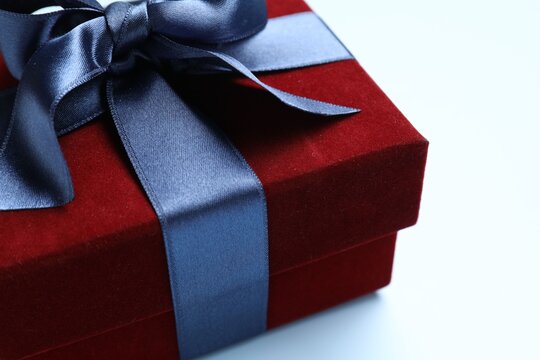 Beautiful velvet gift box on light blue background, closeup