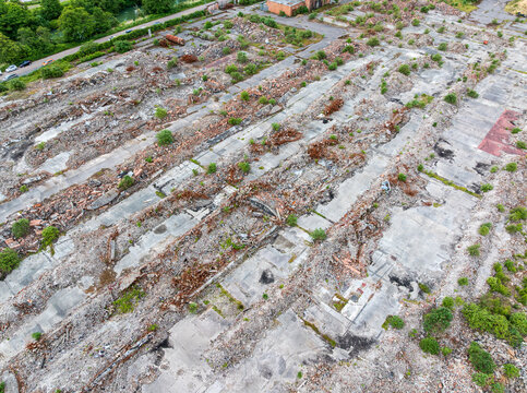 Remnants of demolished structures at Lydney Harbour in Gloucestershire, England, featuring piles of rubble and rebar.