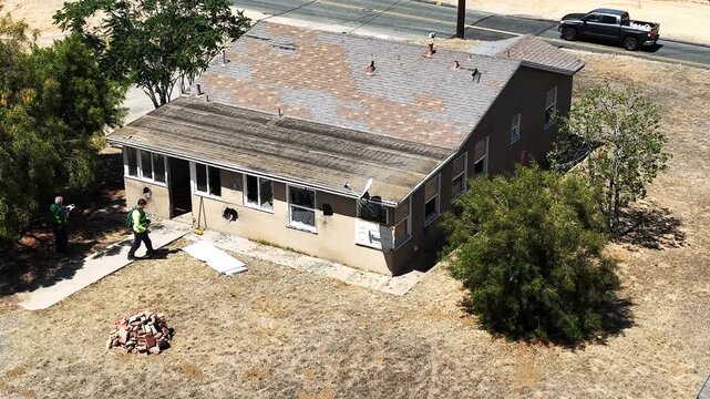 A house used for CERT Community Emergency Community Response Team to practice Search and Rescue with major damage from explosives and structural breaches  looking at a drone view of the building being
