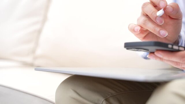 Person hand using stylus pen writing on digital tablet while holding smartphone.Online form completion, Electronic signature,Mobile business,Digital approval,Paperless workflow,Modern productivity tec