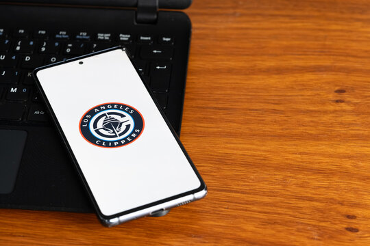 Punta Arenas, Chile &ndash; July 6, 2026: The Los Angeles Clippers basketball team logo displayed on a smartphone screen resting on a laptop keyboard over a wooden table background
