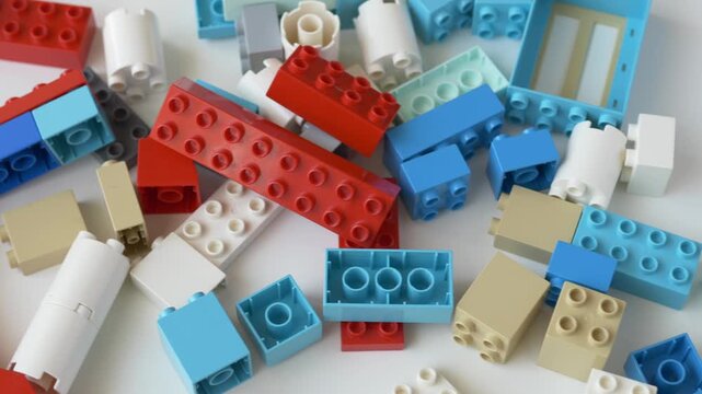 Overhead view of numerous building block pieces in different colors and shapes highlights abundant creative material available for hands on educational construction play.