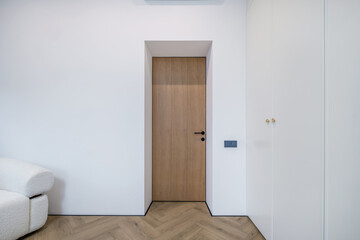 Fototapeta premium door handle on white wooden door in interior. Knob close-up elements. Door handle, fittings for interior design