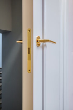 door handle on white wooden door in interior. Knob close-up elements. Door handle, fittings for interior design