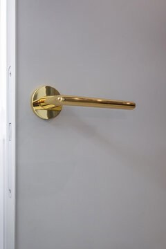 door handle on white wooden door in interior. Knob close-up elements. Door handle, fittings for interior design