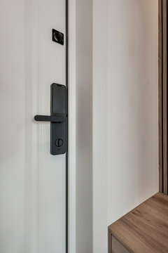 door handle on white wooden door in interior. Knob close-up elements. Door handle, fittings for interior design