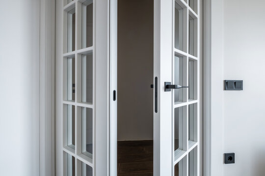 door handle on white wooden door in interior. Knob close-up elements. Door handle, fittings for interior design
