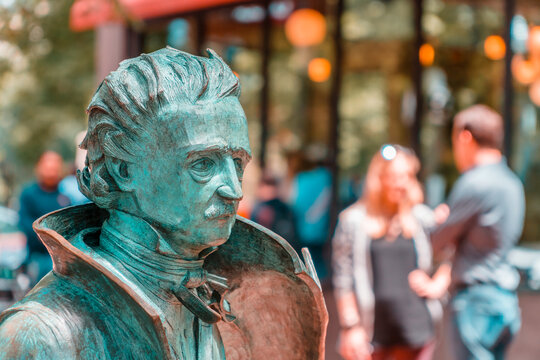 Boston, Massachusetts,USA - June 15,2026:  Close-up view of Edgar Allan Poe statue with tourists in background.