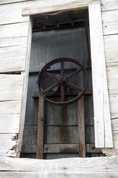 A large pulley wheel in an abandoned warehouse 
