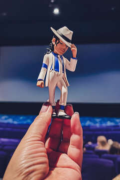 A figurine of Michael Jackson in the hand against the backdrop of a movie screen in a cinema. Moscow, Russia, April 2026