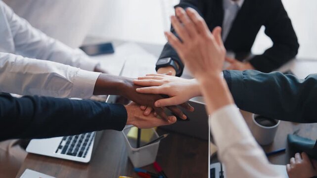Workers of modern international company connecting hands, closeup, diversity. Partnership and teamwork, African, Caucasian, Asian and Indian people working together, unity and connection, synergy