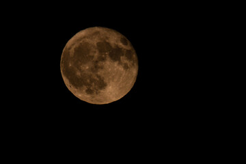 Obraz premium ​Strawberry Full Moon Orange Glow in June Night Sky Greece.