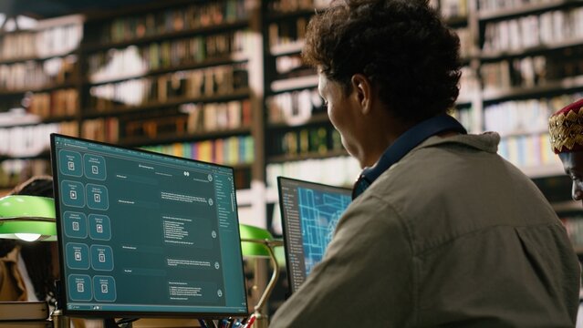 Student using AI brain on desktop and studying in library computer class, with neural network and artificial intelligence, computer monitor at desk used for digital learning.