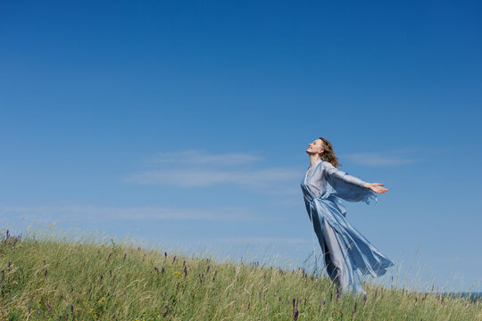 Woman Embracing Nature in a Serene Meditation Pose