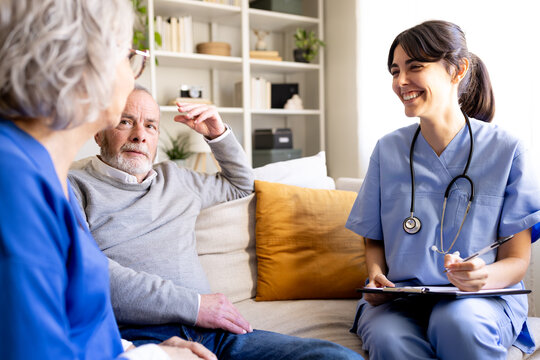 Nurse visiting elderly couple at home for healthcare and support
