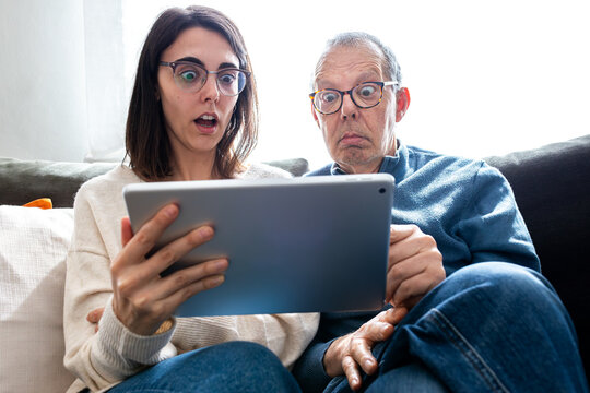 People reacting with shock to surprising news on tablet