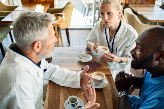 Medical team having coffee break in hospital cafeteria