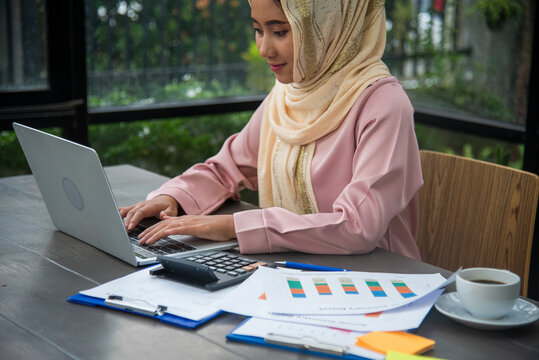 Portrait Muslim woman wear hijab smile face look at camera. Muslim women working. Muslim woman wear hijab work from home office typing laptop keyboard on wooden desk office supply happy smiling face