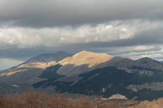 High angle view of a wide mountain valley under cloudy sky in Abruzzo region
