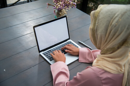 Young Asian arabian muslim women working summary report business graph chart. Crop arabian muslim women working business report graph chart. Portrait Muslim woman wear hijab smile face look at