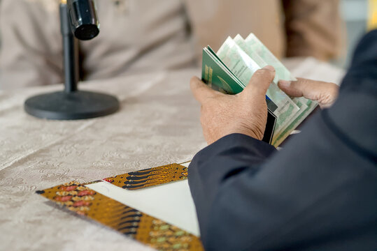 Islamic Marriage Contract Ceremony (Akad Nikah) - Religious Officiant Joining Hands with Groom During Ijab Qabul Ritual