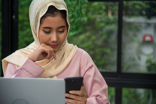 Young Asian arabian muslim women working summary report business graph chart. Crop arabian muslim women working business report graph chart. Portrait Muslim woman wear hijab smile face look at