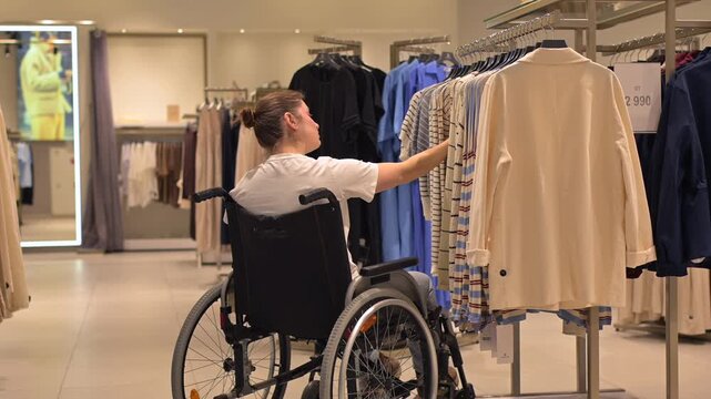 A Caucasian woman in a wheelchair shopping at a mall. 