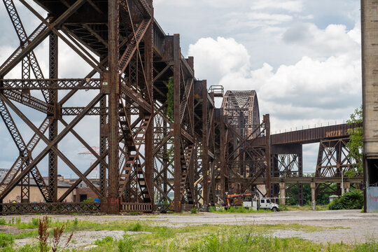 St. Louis, Missouri, United States - 25 June 2026: View of the historic rusted steel trestle bridge structure with industrial architecture under a cloudy sky.
