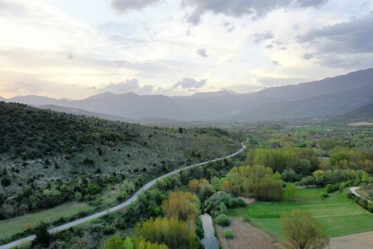 Aerial view of the Tirino River winding through the green landscape of Capestrano, Abruzzo, Italy.