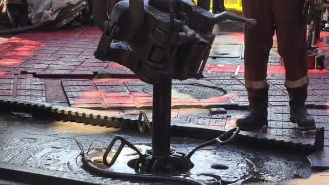 Drilling rig activity - Pull of of hole drill string with oil based mud on the rig floor. Trip out of hole.