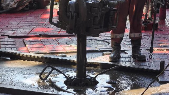 Drilling rig activity - Pull of of hole drill string with oil based mud on the rig floor. Trip out of hole.