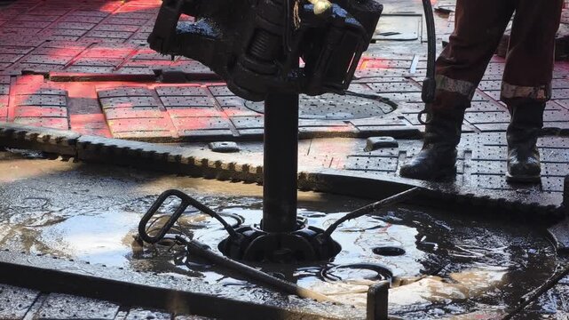 Drilling rig activity - Pull of of hole drill string with oil based mud on the rig floor. Trip out of hole.