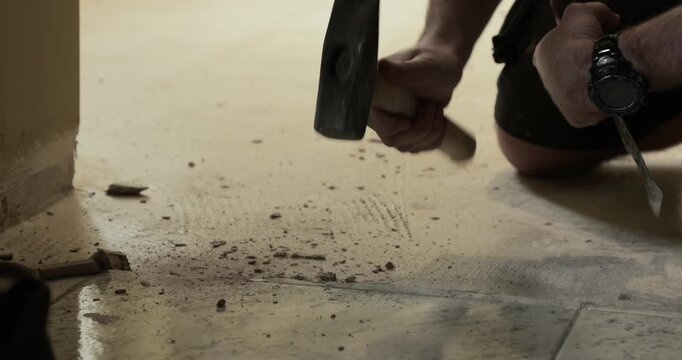 Construction worker replacing tile floor